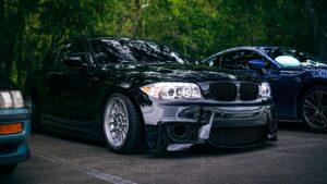 Black BMW with custom wheels and tinted windows representing Utah vehicle customization services